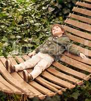 Daydream the day away. A little boy relaxing in a hammock in his backyard.