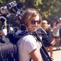 Not prepared to miss a second of the action. Cropped shot of a young cameraman at a festival.