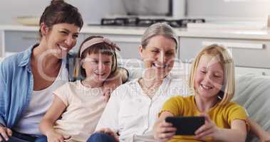 Now say cheese mom. Shot of a grandmother taking a selfie with her daughter and granddaughters.