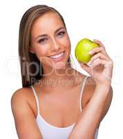Packed with taste and nutrition. A young woman smiling while she holds an apple - isolated.