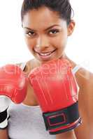 Shes a fitness fighter. A gorgeous young woman wearing boxing gloves.