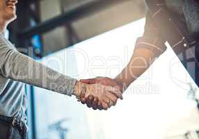 Looking forward to achieving many successes together. Closeup shot of businesspeople shaking hands in an office.