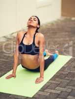 Its important to be both mentally and physically fit. Shot of a beautiful young woman practising yoga outdoors.