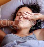 Im not ready to get up yet. Cropped shot of a woman touching her face while waking up.