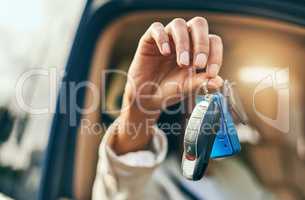 The keys to the transport. Closeup of an unrecognizable businessperson holding a set of keys while being seated inside of a car during the day.