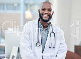 Your health is important to me. Shot of a handsome young doctor standing alone in his clinic.
