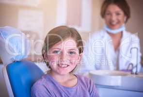 Oral health is an important part of a childs health. Shot of a little girl at the dentist for a checkup.