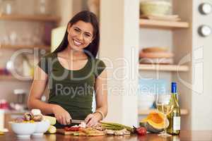 Happiness is home cooking. Shot of an attractive young woman at home.