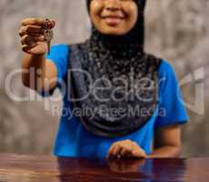 Enjoy your stay. Shot of a smiling muslim thai woman standing at a hotel reception handing over a room key.