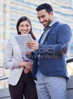 If we stay together well never fail. Shot of two coworkers using a digital tablet together.