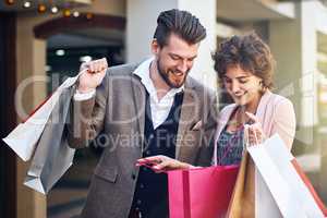 Look at all the items I got. Shot of a woman showing her boyfriend what she bought while out shopping.