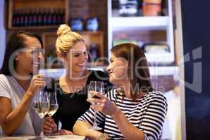 Shes a bit of a wine connoisseur. Cropped shot of three women enjoying a glass of white wine in a restaurant.