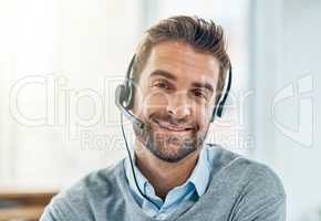 Customer care is very important to us. Portrait of a young call centre agent working in an office.