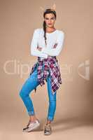 Show them who you truly are. Studio shot of a young woman wearing costume rabbit ears against a plain background.