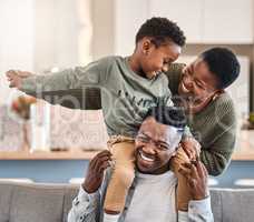 A family is sewn together with fun memories. Shot of a happy young family playing together on the sofa at home.