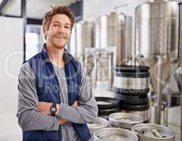 Making a fine brew. Portrait of a man working in a microbrewery.