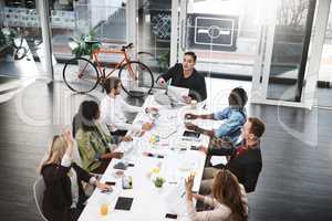 Assigning a task to each team member. Shot of a group of businesspeople having a meeting in a boardroom.