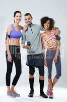 My workout buddies. Portrait of three young adults wearing sports clothing in studio.