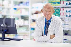 Ive seen a lot of remedies come and go.... Portrait of a senior pharmacist working at a counter.