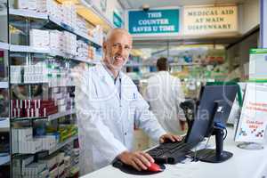 Our system allows us to swiftly locate the medication you need. Portrait of a mature pharmacist working on a computer in a chemist.