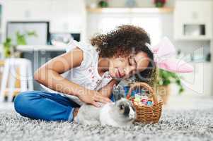 Spending today with some-bunny special. Shot of a little girl playing with a rabbit at home.