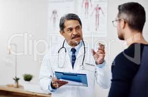 We need to get you started on the treatment immediately. Shot of a confident mature male doctor consulting a patient inside a hospital during the day.