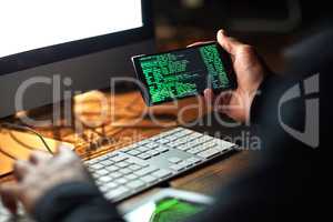 Secure your system before its too late. Cropped shot of an unidentifiable hacker cracking a computer code in the dark.