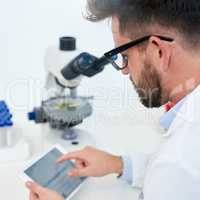 Technology helps facilitate cutting-edge medical development. Cropped shot of a male scientist working on a digital tablet in a lab.