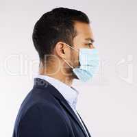 The whole world is affected by this virus. Studio shot of a young businessman wearing a face mask against a white background.