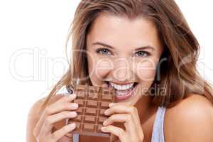 Mmmm...so delicious. An attractive young woman eating a slab of chocolate.