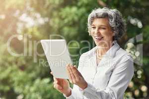 Just got email confirmation on another successful deal. Cropped shot of a mature businesswoman working on a digital tablet.