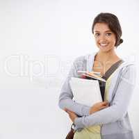 So happy at college. Cropped studio shot of a college student smiling widely with books in her arms.