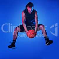 I play to win. Blue filtered shot of a sportsman playing basketball in the studio.