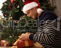 Spreading the Christmas spirit. Shot of a handsome young man getting ready for Christmas.