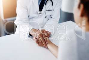 There is not one thing you have to worry about. Cropped shot of an unrecognizable doctor holding a patients hand to comfort them and make them feel at ease.