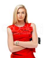 Waiting for her date to arrive. A stunning young blonde woman standing with arms folded while holding a clutch bag.