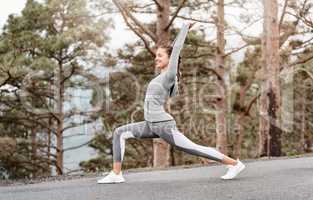 Stretch to a stronger, leaner and healthier you. Shot of a sporty young woman stretching her body while exercising outdoors.