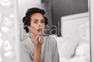 Nothing but the best will do for today. Shot of a woman applying makeup for a special occasion.