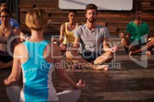 Yoga is the science to be in the here and now. Shot of a yoga instructor instructing her class.