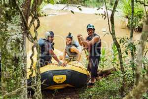 Were ready to have some rafting fun. Shot of a group of friends out river rafting on a sunny day.