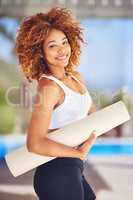 Becoming healthy is the best decision youll ever make. Cropped shot of a sporty young woman holding her yoga mat.