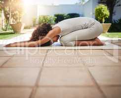 Getting fitter through yoga. Full length shot of a sporty young woman practicing yoga outdoors.