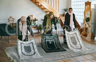 Preparation is important. Shot of a group of muslim women laying down their prayer mats in preparation.