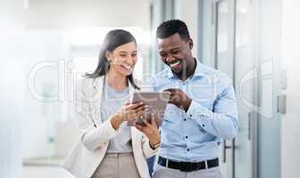 Think of your competitor as your motivation. Shot of two businesspeople discussing something on a digital tablet.