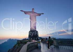 Glorious at sundown. A group of tourists on the path to see the statue, Christ the Redeemer in Rio.