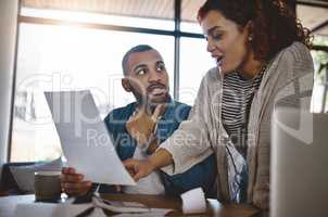 Ensure you delve into your budget with a solid plan. Shot of a young couple planning their budget together at home.