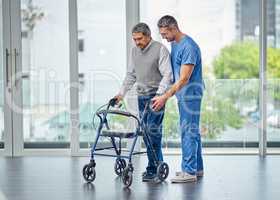 Improving mobility impairment one step at a time. Shot of a nurse helping a senior man with a walker.