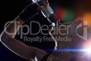 Nothing tastes better than this after an intense workout. Studio shot of a young sportswoman drinking from a water bottle against a dark background.