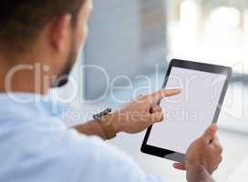 My tablet helps me stay organised. Shot of a young businessman using a digital tablet at work.