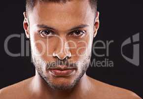 Magnificently masculine. Studio portrait of a handsome young man against a black background.
